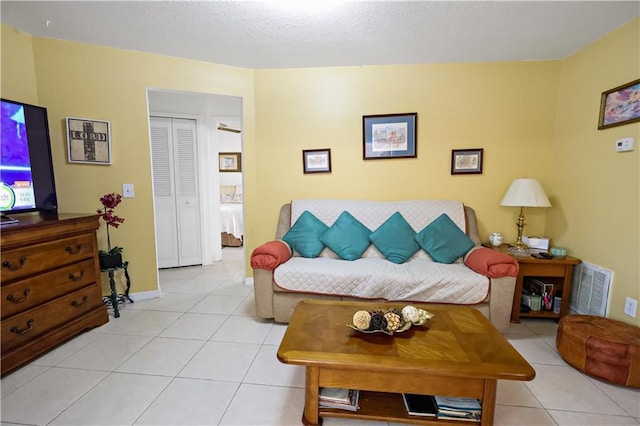 2582 Longwood Blvd, Melbourne, FL 32934 - living room with light tile patterned floors and a textured ceiling