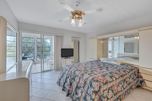 1902 Bermuda Cir Unit L2, Coconut Creek, FL 33066 - bedroom featuring access to exterior, light tile patterned flooring, a textured ceiling, and a ceiling fan