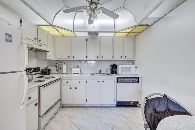 1902 Bermuda Cir Unit L2, Coconut Creek, FL 33066 - kitchen with white appliances, under cabinet range hood, light countertops, ceiling fan, and white cabinetry