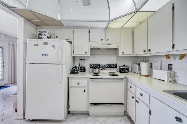 1902 Bermuda Cir Unit L2, Coconut Creek, FL 33066 - kitchen with white appliances, under cabinet range hood, tasteful backsplash, and light countertops