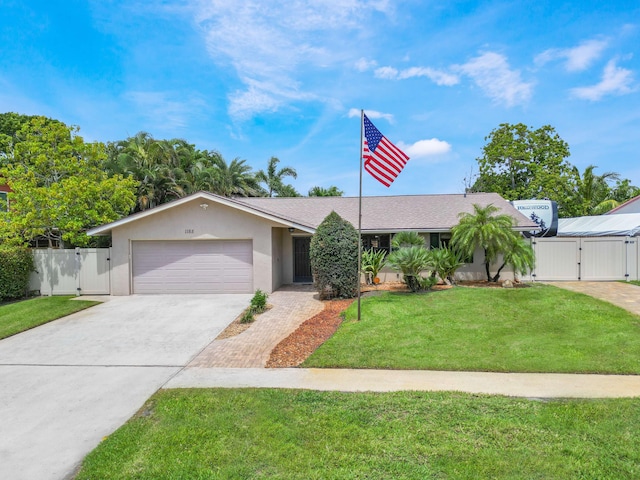 1155 Woodcrest Rd W, West Palm Beach, FL 33417 - ranch-style house with a gate, a garage, driveway, and stucco siding