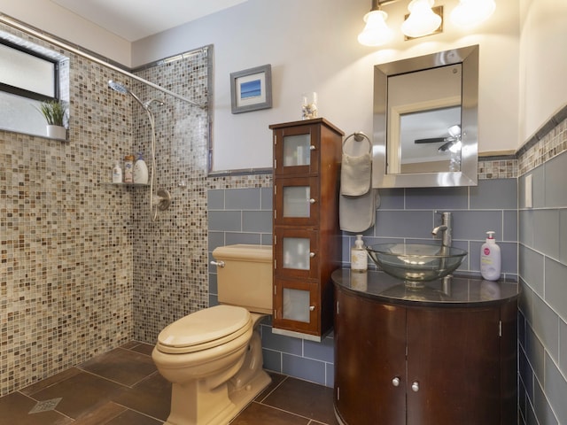 1155 Woodcrest Rd W, West Palm Beach, FL 33417 - full bath featuring tile walls, a tile shower, tile patterned floors, vanity, and wainscoting