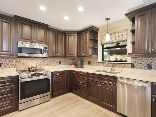 1155 Woodcrest Rd W, West Palm Beach, FL 33417 - kitchen with appliances with stainless steel finishes, open shelves, dark brown cabinets, tasteful backsplash, and light countertops