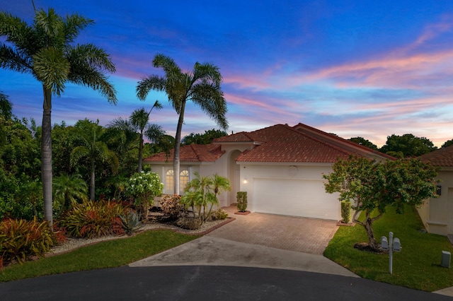 7200 NW Turtle Walk, Boca Raton, FL 33487 - mediterranean / spanish-style home with driveway, a garage, a tile roof, stucco siding, and a front lawn