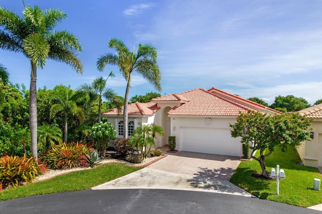 7200 NW Turtle Walk, Boca Raton, FL 33487 - mediterranean / spanish-style house with driveway, a garage, stucco siding, a tiled roof, and a front lawn
