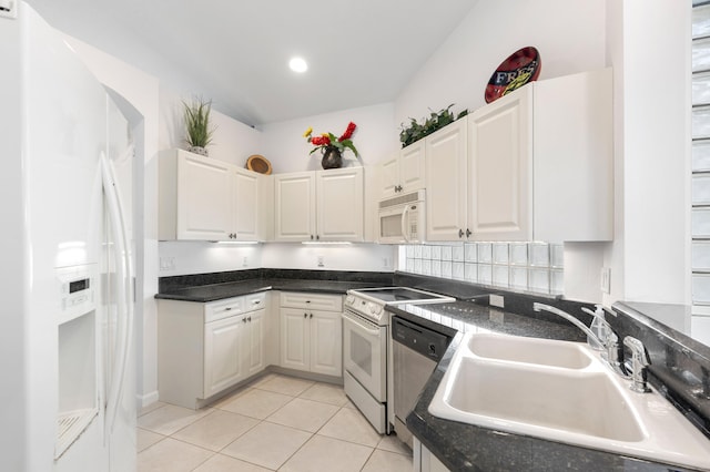 7200 NW Turtle Walk, Boca Raton, FL 33487 - kitchen with white appliances, light tile patterned floors, dark countertops, white cabinets, and recessed lighting