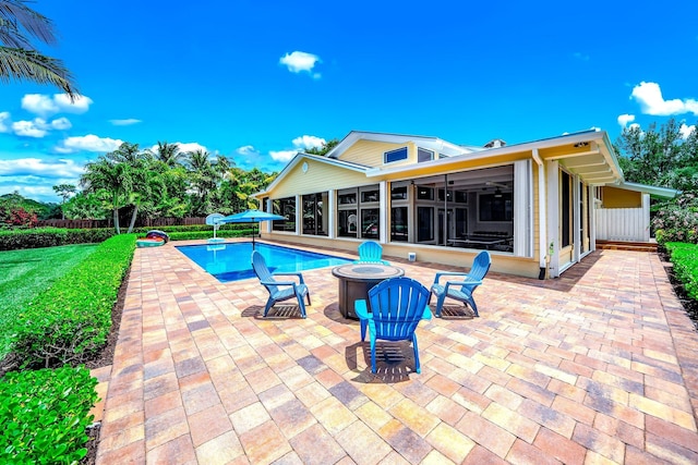 1819 SW Crane Crk, Palm City, FL 34990 - view of pool with a sunroom, an outdoor fire pit, and a patio