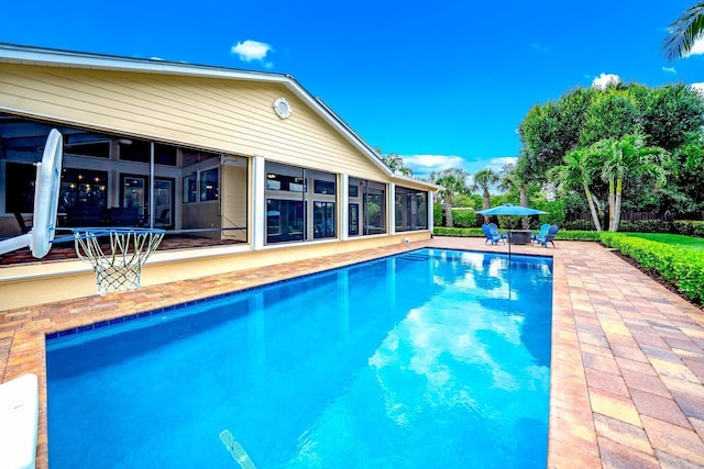 1819 SW Crane Crk, Palm City, FL 34990 - swimming pool featuring a sunroom and a patio