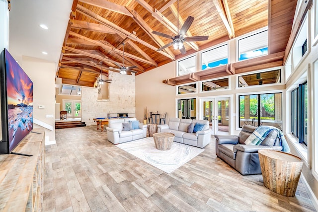 1819 SW Crane Crk, Palm City, FL 34990 - living area with a wooden ceiling with exposed beams, a ceiling fan, high vaulted ceiling, wood finished floors, and french doors