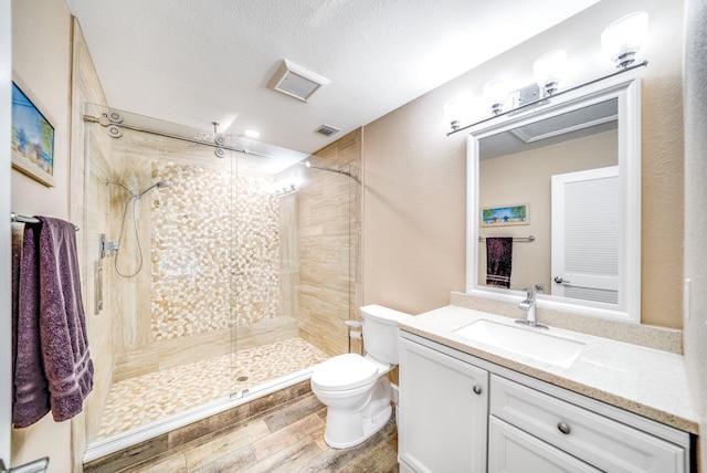 1819 SW Crane Crk, Palm City, FL 34990 - full bath with vanity, a shower stall, wood finished floors, and a textured ceiling