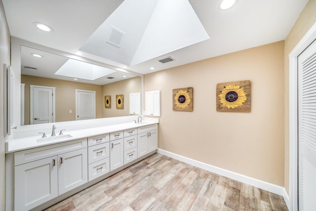 1819 SW Crane Crk, Palm City, FL 34990 - full bath featuring a skylight, double vanity, wood finished floors, recessed lighting, and a closet