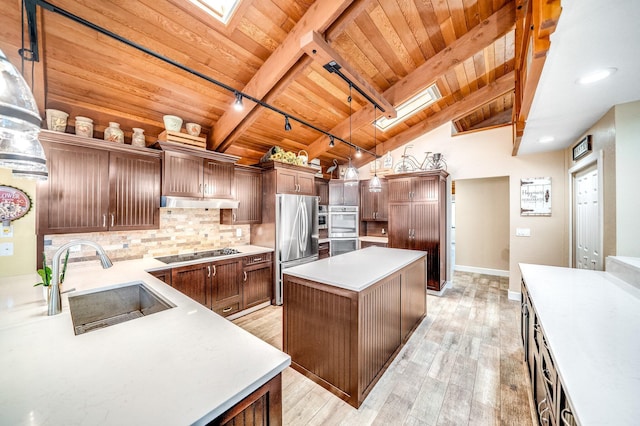 1819 SW Crane Crk, Palm City, FL 34990 - kitchen with wood ceiling, appliances with stainless steel finishes, rail lighting, light wood-style floors, and light countertops