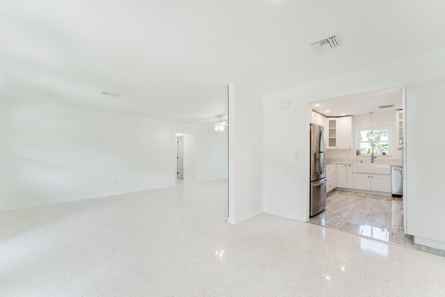 450 NE 38th St, Boca Raton, FL 33431 - unfurnished living room with a ceiling fan and dark speckled floor