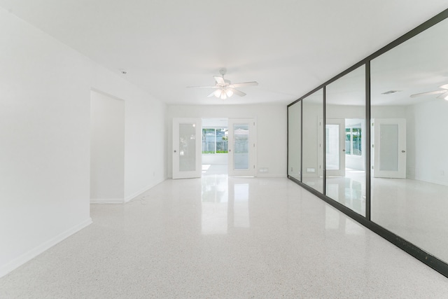 450 NE 38th St, Boca Raton, FL 33431 - spare room with a ceiling fan and speckle patterned floor