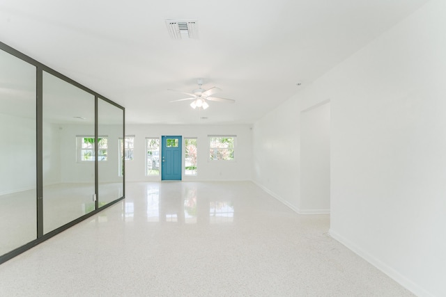450 NE 38th St, Boca Raton, FL 33431 - unfurnished room with plenty of natural light, a ceiling fan, and speckle patterned floor