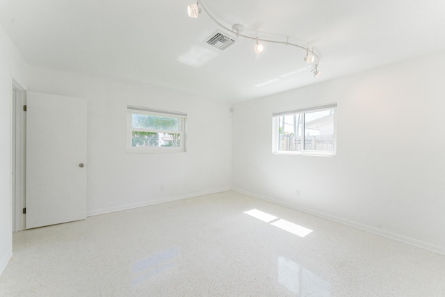 450 NE 38th St, Boca Raton, FL 33431 - unfurnished room with healthy amount of natural light and speckle patterned floor