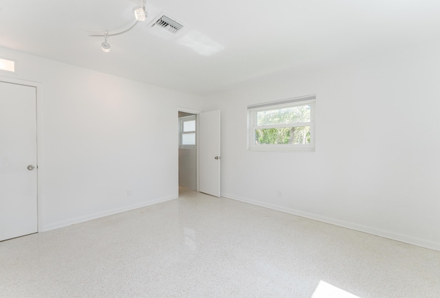450 NE 38th St, Boca Raton, FL 33431 - empty room with speckle patterned floor and track lighting