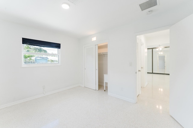 450 NE 38th St, Boca Raton, FL 33431 - unfurnished bedroom featuring speckle patterned floor, a spacious closet, and a closet