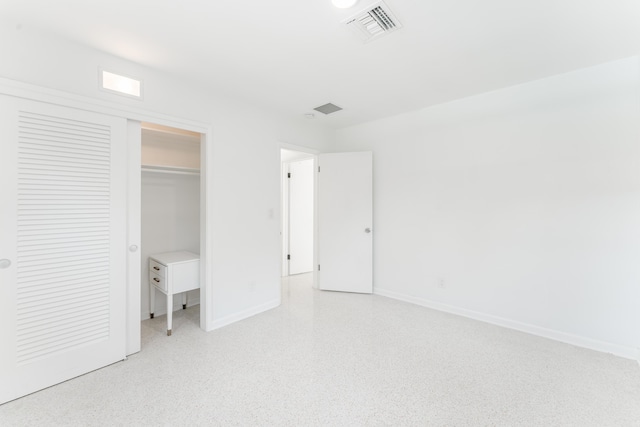 450 NE 38th St, Boca Raton, FL 33431 - unfurnished bedroom with dark aggregate flooring and a closet