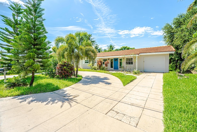 450 NE 38th St, Boca Raton, FL 33431 - ranch-style house with concrete driveway, a garage, stucco siding, and a tile roof