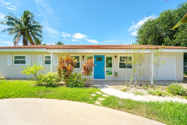450 NE 38th St, Boca Raton, FL 33431 - ranch-style home with an attached garage, stucco siding, and a tile roof