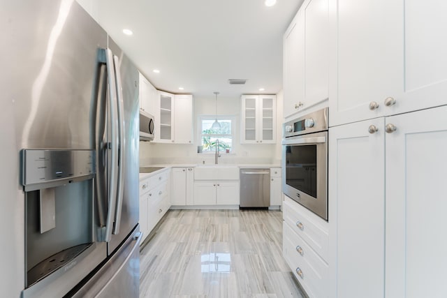 450 NE 38th St, Boca Raton, FL 33431 - kitchen with appliances with stainless steel finishes, light countertops, glass insert cabinets, white cabinets, and recessed lighting
