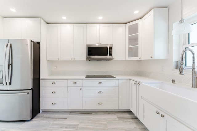 450 NE 38th St, Boca Raton, FL 33431 - kitchen with stainless steel appliances, white cabinetry, glass insert cabinets, recessed lighting, and light stone counters