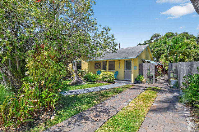 1815 N N St, Lake Worth Beach, FL 33460 - bungalow with stucco siding, a gate, and driveway