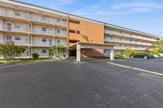230 NE 26th Ave Unit 213, Boynton Beach, FL 33435 - hall featuring light tile patterned floors and baseboards