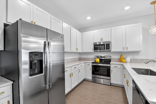 14929 Three Ponds Trl, Delray Beach, FL 33446 - kitchen featuring stainless steel appliances, light wood-style flooring, light stone counters, white cabinets, and recessed lighting