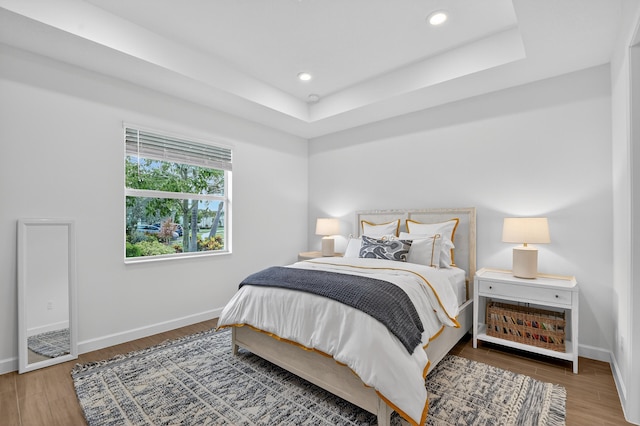 14929 Three Ponds Trl, Delray Beach, FL 33446 - bedroom with wood finished floors, a tray ceiling, and recessed lighting