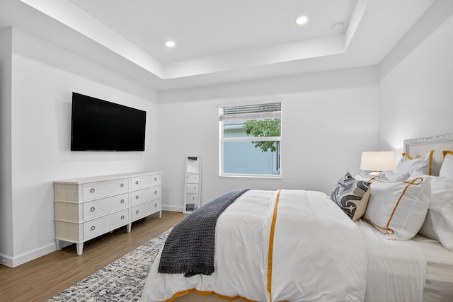 14929 Three Ponds Trl, Delray Beach, FL 33446 - bedroom with wood finished floors, a raised ceiling, and recessed lighting