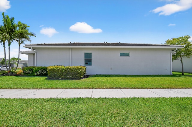 14929 Three Ponds Trl, Delray Beach, FL 33446 - view of home's exterior featuring stucco siding and a lawn