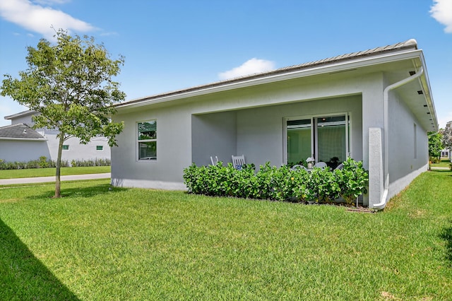 14929 Three Ponds Trl, Delray Beach, FL 33446 - view of property exterior featuring a yard and stucco siding