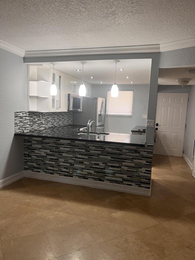 9467 Boca Cove Cir Unit 804, Boca Raton, FL 33428 - kitchen with stainless steel appliances, white cabinetry, dark countertops, ornamental molding, and a textured ceiling