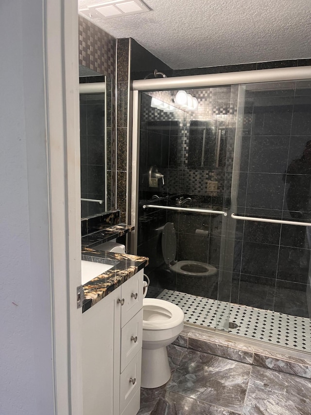 9467 Boca Cove Cir Unit 804, Boca Raton, FL 33428 - bathroom with vanity, a shower stall, a textured ceiling, and marble finish flooring