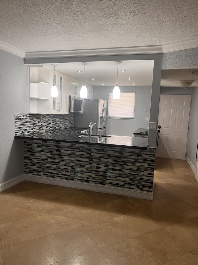 9467 Boca Cove Cir Unit 804, Boca Raton, FL 33428 - kitchen with stainless steel appliances, dark countertops, white cabinetry, crown molding, and pendant lighting
