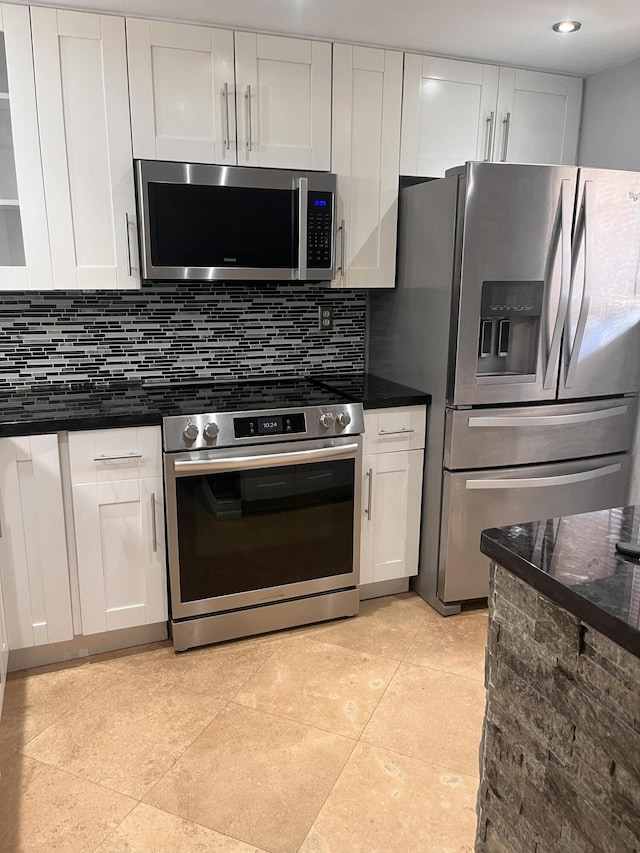 9467 Boca Cove Cir Unit 804, Boca Raton, FL 33428 - kitchen with appliances with stainless steel finishes, white cabinets, and decorative backsplash