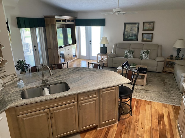 3053 SE Darien Rd, Port Saint Lucie, FL 34952 - kitchen with open floor plan, plenty of natural light, light wood-style flooring, and a kitchen breakfast bar