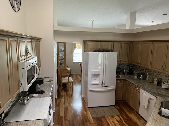 3053 SE Darien Rd, Port Saint Lucie, FL 34952 - kitchen with white appliances, tasteful backsplash, dark wood finished floors, a textured ceiling, and stone countertops