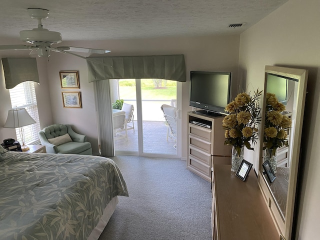 3053 SE Darien Rd, Port Saint Lucie, FL 34952 - carpeted bedroom with access to outside, multiple windows, a textured ceiling, and ceiling fan