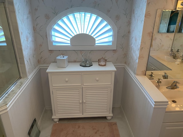 3053 SE Darien Rd, Port Saint Lucie, FL 34952 - full bathroom featuring wallpapered walls, a wainscoted wall, and vanity