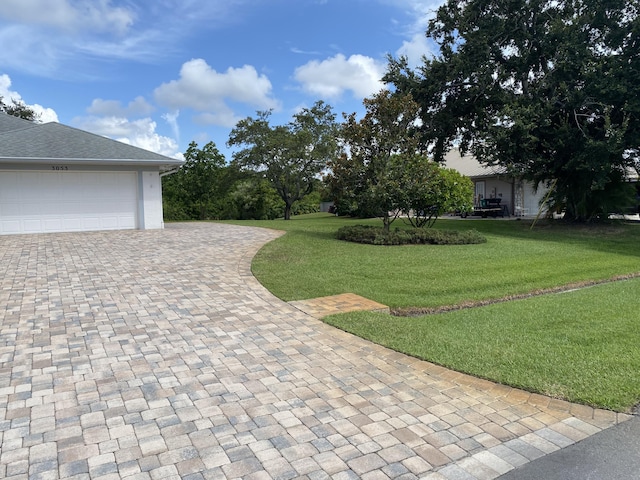 3053 SE Darien Rd, Port Saint Lucie, FL 34952 - view of green lawn featuring decorative driveway and a garage