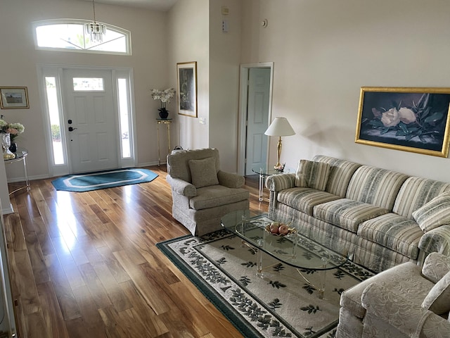 3053 SE Darien Rd, Port Saint Lucie, FL 34952 - living area featuring wood finished floors, a towering ceiling, and a chandelier