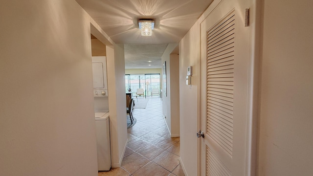 4090 Tivoli Ct Unit 303, Lake Worth, FL 33467 - corridor featuring stacked washer and clothes dryer and light tile patterned flooring