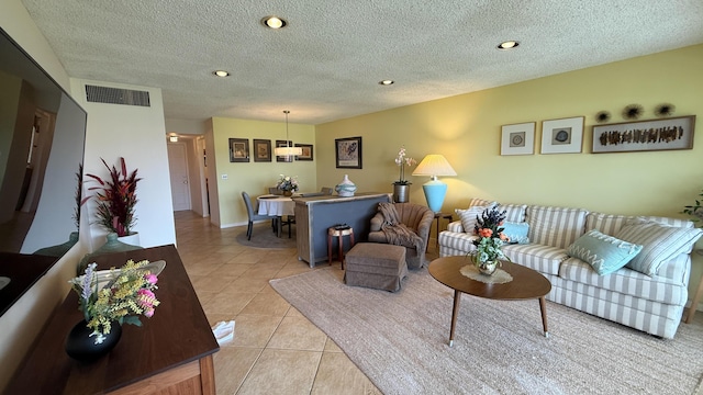 4090 Tivoli Ct Unit 303, Lake Worth, FL 33467 - living area featuring light tile patterned floors, recessed lighting, and a textured ceiling