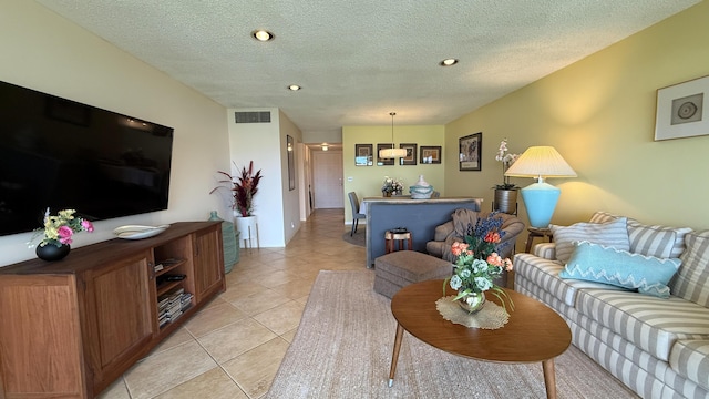 4090 Tivoli Ct Unit 303, Lake Worth, FL 33467 - living room with light tile patterned floors, a textured ceiling, and recessed lighting