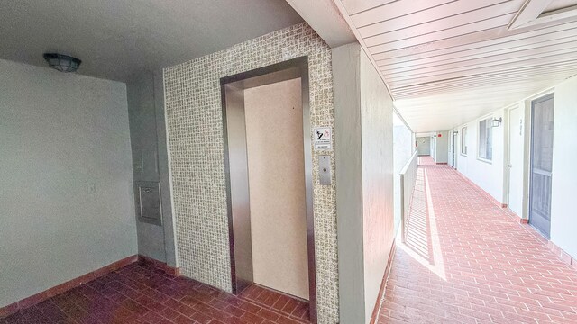 4090 Tivoli Ct Unit 303, Lake Worth, FL 33467 - hallway with brick floors