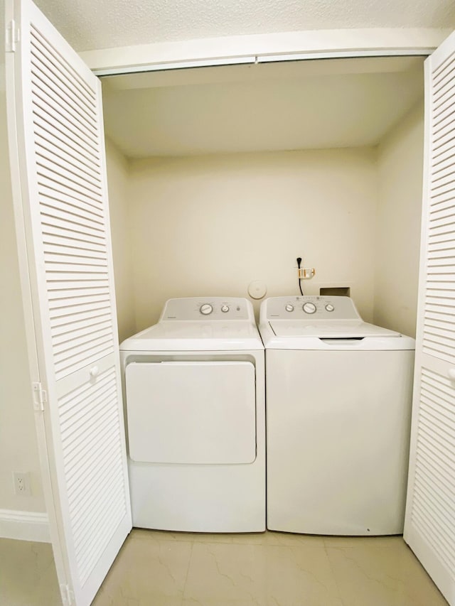 815 W Boynton Beach Blvd Unit 7-102, Boynton Beach, FL 33426 - laundry area with washing machine and clothes dryer and light marble finish floors
