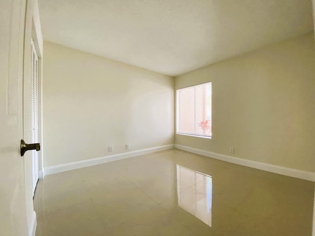 815 W Boynton Beach Blvd Unit 7-102, Boynton Beach, FL 33426 - unfurnished room featuring baseboards and tile patterned floors